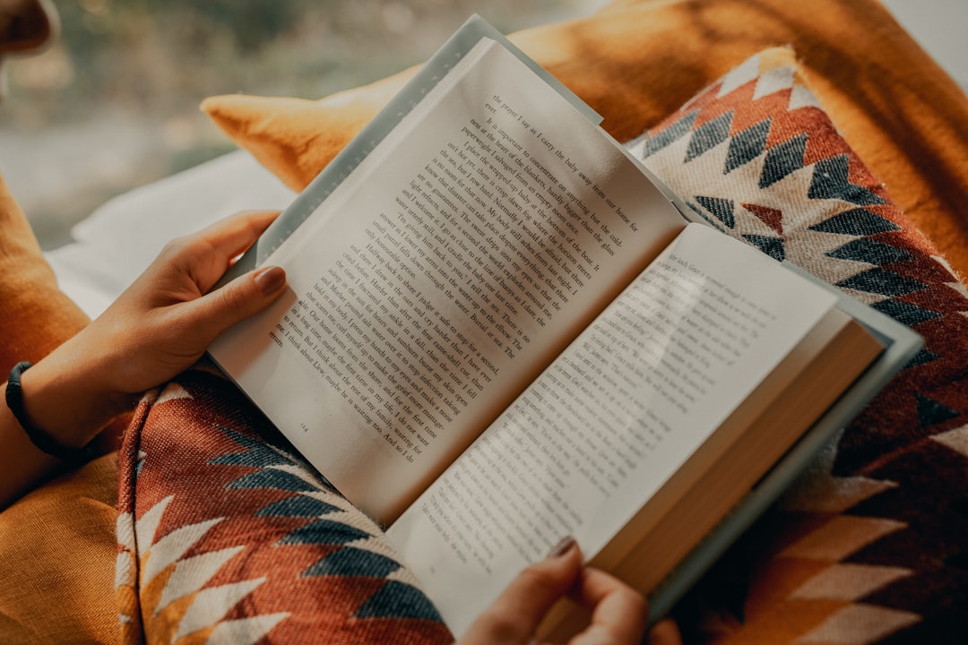 person reading a book in a library
