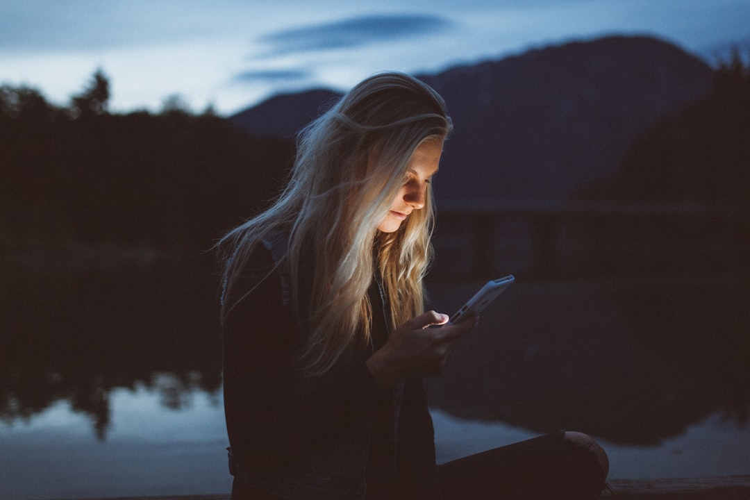 sad young girl looking at smartphone